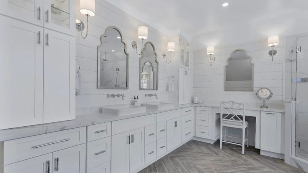 A tiled walk-in glass shower with a grey vanity in a Seacoast New Hampshire bathroom by Benchmark