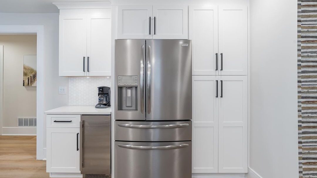 White shaker pantry wall with a built-in refrigerator and coffee station in a remodeled Seacoast NH kitchen